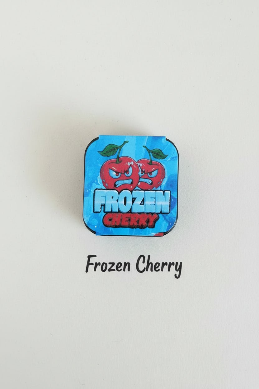 Blue candy wrapper with red cherry design on a wooden surface