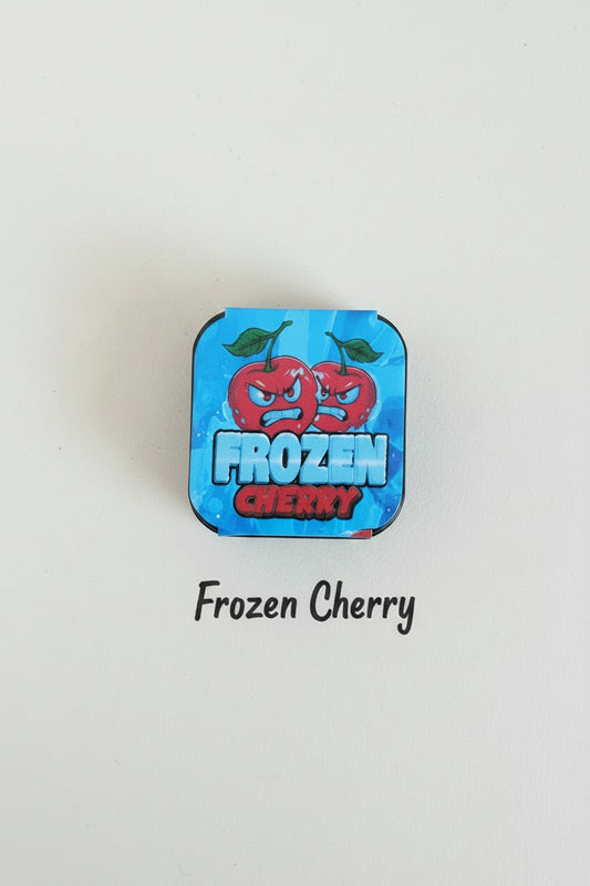 Blue candy wrapper with red cherry design on a wooden surface